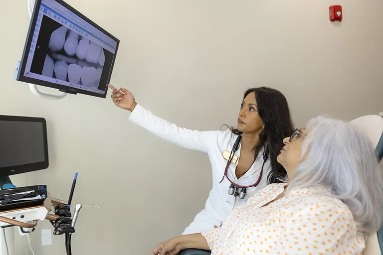 Dr. Hemita klose reviewing dental x-rays with a patient at naples dental boutique in naples, florida.