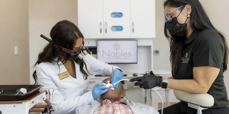 Dr. Hemita klose performing a dental procedure on a florida veteran at naples dental boutique in naples, fl.